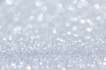 Shining silver glitter background. Abstract texture with bokeh effect.