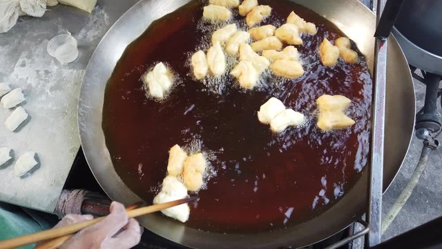 Youtiao, also known as Chinese fried churros, Chinese cruller, Chinese oil stick, Chinese doughnut, You Char Kway/Cakwe/Cakoi/Kueh/Kuay, and fried breadstick