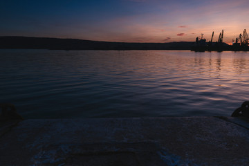 Fototapeta na wymiar Autumn sunset at the sea station with ships.