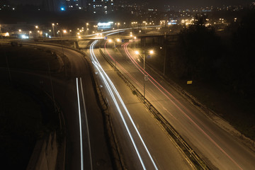 Autumn night light trails at entrance of the city.