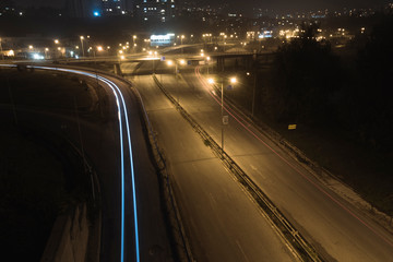 Autumn night light trails at entrance of the city.