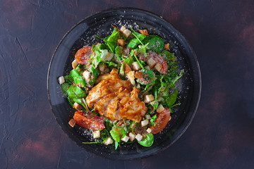 Fried turkey fillet with arugula, chard, corn salad sprinkled with grated cheese and bread chips