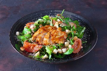 Fried turkey fillet with arugula, chard, corn salad sprinkled with grated cheese and bread chips