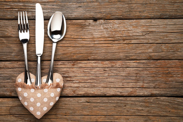 Valentine's Day, pillow place card hearts and cutlery on old wooden table