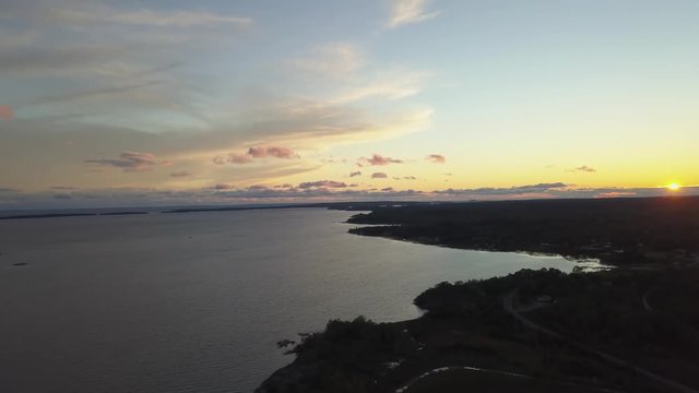 Aerial panoramic landscape view of a beautiful bay on the Great Lakes, Lake Huron, during a vibrant sunset. Located Northwest from Toronto, Ontario, Canada. Still Image Continuous Animation