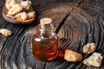 A bottle of styrax benzoin essential oil with benzoin resin