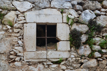 Old window with bars in old village (Piskopiano) on Crete Island Greece.