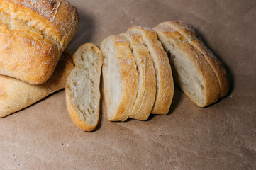 Gluten free homemade bread. Gluten-free pieces of wheat bread on craft paper.