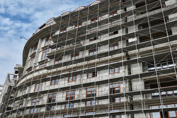 new building under construction, scaffolding and concrete
