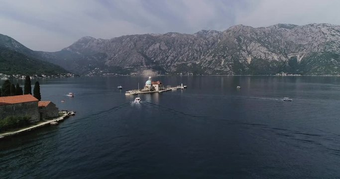 Boat in the Bay of Kotor. Montenegro, the water of the Adriatic Sea. Aerial photography drone.