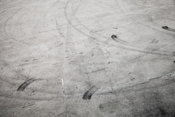 Dark tire tracks on gray concrete road