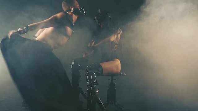 Sexy man and woman in mask in smoke background