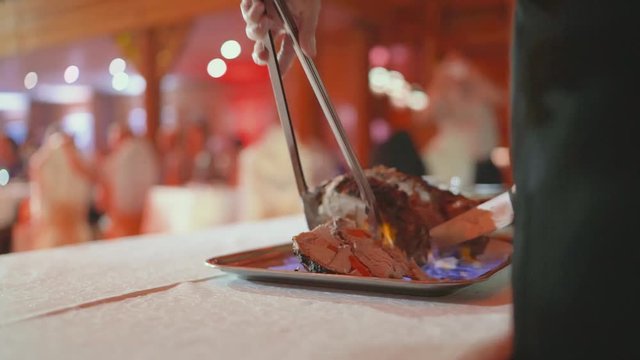Made from pig's front foot. Carpaccio. Cut ham meat in a restaurant. Chef cuts the burning ham meat. Ram meat Chef cuts lamb in a restaurant.