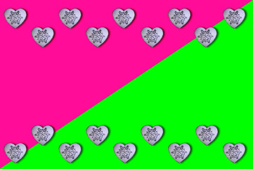 White hearts with glitter silver snowfalakes pattern on a plastic pink and UFO green background. Saint Valentine's Day concept. Flat lay. Top view.