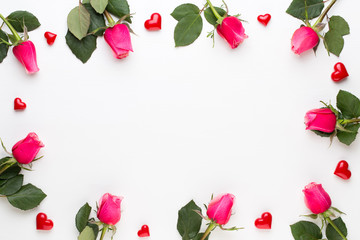 Flowers composition. Frame made of red rose on white background. Flat lay, top view, copy space.