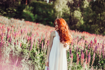 Happy positive smiling cheerful ginger haired young girl with freckles laughing outdoors in the...