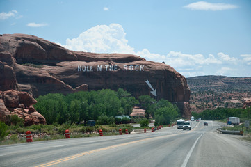 Landmark "Hole in the rock" with street in front, USA