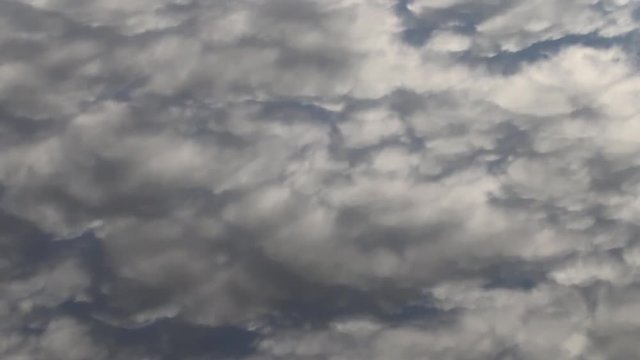 Magical inconstancy. Moire waves of clouds are reflected in the calm mirror water. The changeability and fluidity of shapes and colors, the play of colors
