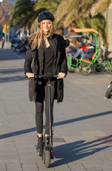 Woman riding an electric scooter in winter