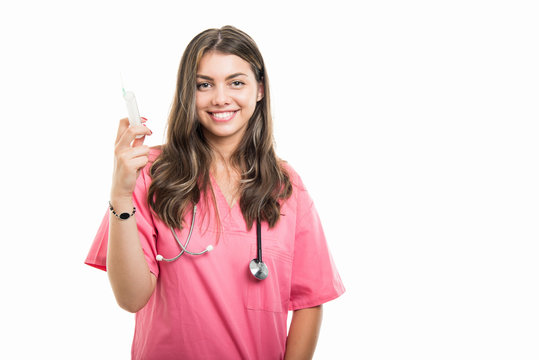 Portrait of beautiful young doctor holding syringe