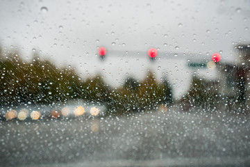 Raindrops on the windshield on a rainy day while stopped at a traffic light; San Francisco bay...
