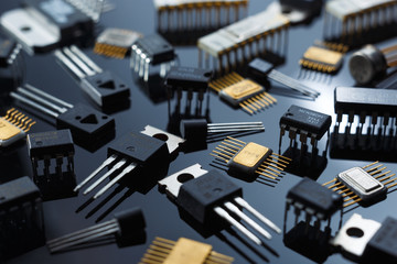 Microelectronic components close-up. Golden electronic microchips. - obrazy, fototapety, plakaty