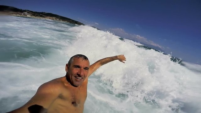 Fit Middle-Aged Man Taking Selfie Video In The Ocean Waves - Slow Motion