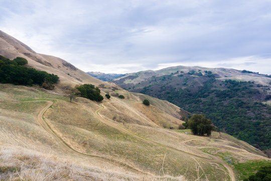 Hiking trail through the hills and valleys of Sierra Vista Open Space Preserve on a rainy day, San Jose, Santa Clara county, California