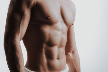 Close up of topless muscular male chest and arms