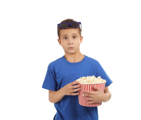 Fototapeta premium Emotional boy with 3D glasses and popcorn during cinema show on white background