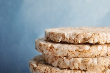 Stack of crunchy rice cakes on color background, closeup. Space for text