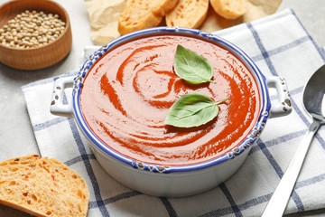 Dish with delicious fresh homemade tomato soup on table