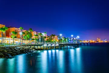 Gordijnen Night view of Molos promenade with several piers leading to the mediterranean sea in Limassol, Cyprus © dudlajzov