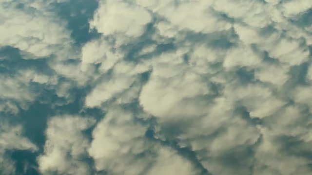 Magical inconstancy. Moire waves of clouds are reflected in the calm mirror water. The changeability and fluidity of shapes and colors, the play of colors
