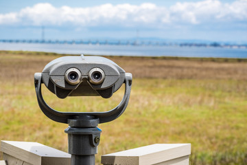 Outdoor daytime viewing telescope looking over the marshes of south San Francisco bay area, Palo...