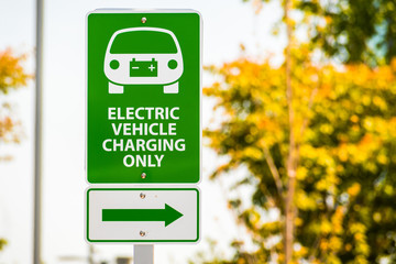 "Electric Vehicle charging only" sign posted in a parking lot