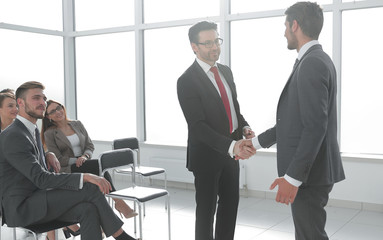 businessmen handshaking after striking grand deal