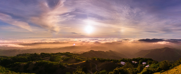 Panoramic view of a sunset over a sea of clouds covering south San Francisco bay area; beautiful...