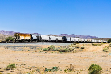 Fototapeta na wymiar Freight train cars stopped on a desert area, Inyo County, California