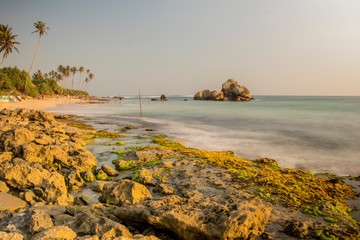 Long Exposure photography of Sunset Beach with Coral Reefs and stones at Koggala Sri Lanka