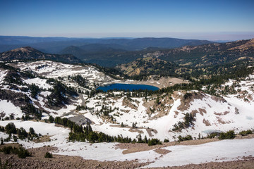 Aerial view of Lake Helen and the surrounding valley as seen from the trail to Lassen Peak; the parking lot for the Lassen Peak trail visible on the left, Lassen Volcanic National Park, California