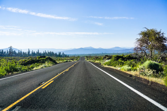 Driving on a straight, empty road in Shasta County, Northern California