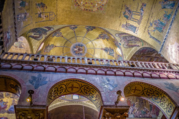 Fototapeta na wymiar Interior ceiling view of St. Mark's Basilica in Venice with beautiful artwork, mosaics, painting, dome and arches