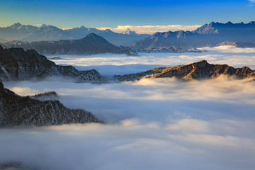 Obraz na płótnie Canvas Dawn, Sunrise above the clouds - Niubeishan Landscape, Cattle Back Mountain, Sichuan Province China. Snow mountains, Ice Frost and Rime. Frozen Winter Landscape, Frigid Cold Atmosphere. Sea of Clouds