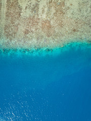 Aerial image from a drone of blue lagoon at Bora Bora island, Tahiti, French Polynesia, South Pacific Ocean (Bora Bora Aerial).