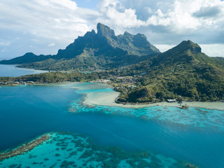 Aerial image from a drone of blue lagoon and Otemanu mountain at Bora Bora island, Tahiti, French...