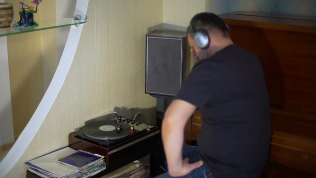 Man and Vintage Vynyl Turntable