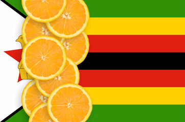 Zimbabwe flag and citrus fruit slices vertical row