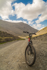 Fototapeta na wymiar Red bike on the mountain road
