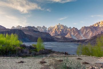 Tupopdan mountain also known as Passu Cones or Passu Cathedral, big rocks all over the place and blue crystal of Hunza river at sunset time ,Northern of Pakistan